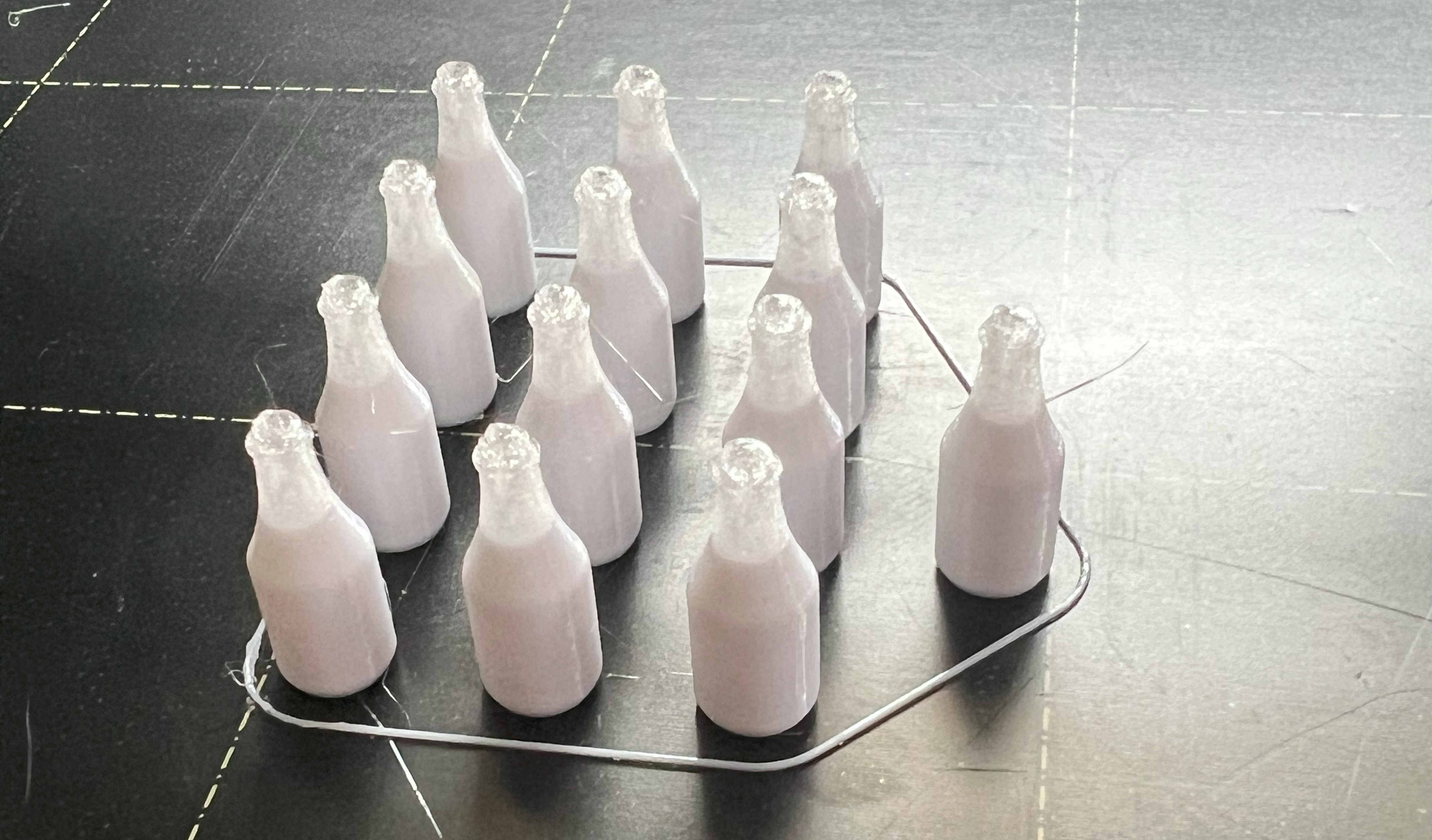 13 3d printed milk bottles scale models on the printer bed