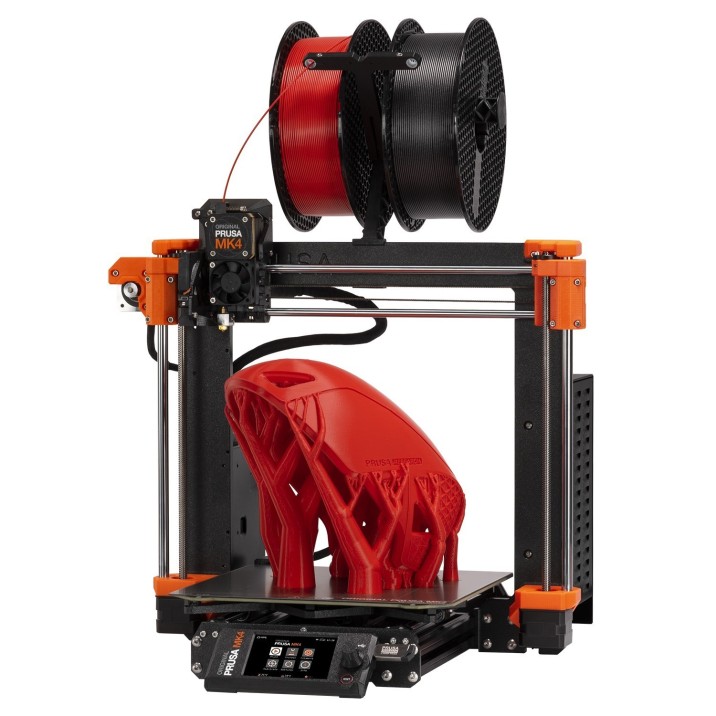 Prusa MK4 3D Printer with red and black filament above and a 3d printed mask with organic supports on the print bed